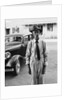 Portrait of old man wearing hat glasses tie & suspenders car in background by Anonymous