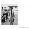 Portrait of old man wearing hat glasses tie & suspenders car in background by Anonymous