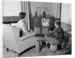 Couple husband wife watching console television in living room by Anonymous