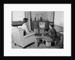 Couple husband wife watching console television in living room by Anonymous