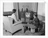 Couple husband wife watching console television in living room by Anonymous