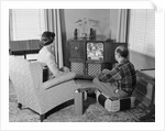 Couple husband wife watching console television in living room by Anonymous