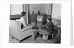 Couple husband wife watching console television in living room by Anonymous