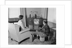 Couple husband wife watching console television in living room by Anonymous