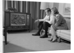 Couple man woman sitting on couch watching television by Anonymous