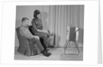 Couple man woman sitting chair watching portable television by Anonymous