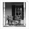 Couple man woman sitting on porch in rocking chairs holding newspapers up hiding their faces by Anonymous