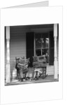 Couple man woman sitting on porch in rocking chairs holding newspapers up hiding their faces by Anonymous