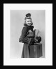 Smiling young blond woman wearing hat fur trimmed coat carrying packages by Anonymous
