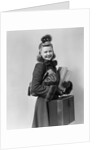 Smiling young blond woman wearing hat fur trimmed coat carrying packages by Anonymous