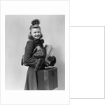 Smiling young blond woman wearing hat fur trimmed coat carrying packages by Anonymous