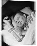 Man asleep sleeping in bed wearing pajamas by Anonymous