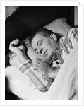 Man asleep sleeping in bed wearing pajamas by Anonymous