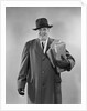 Smiling man carrying shopping boxes wearing hat coat gloves by Anonymous