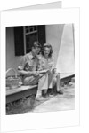 Man woman sitting on porch of farmhouse reading catalog by Anonymous
