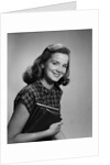 Young smiling woman holding books looking at camera by Anonymous