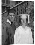 Graduation couple in cap and gown by Anonymous
