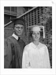 Graduation couple in cap and gown by Anonymous