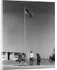 Group 4 school children looking up at american flag by Anonymous