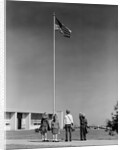 Group 4 school children looking up at american flag by Anonymous