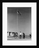 Group 4 school children looking up at american flag by Anonymous