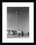 Group 4 school children looking up at american flag by Anonymous
