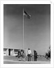 Group 4 school children looking up at american flag by Anonymous