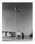 Group 4 school children looking up at american flag by Anonymous