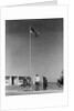 Group 4 school children looking up at american flag by Anonymous