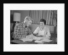 Couple man woman at table working on household accounts bills by Anonymous