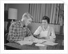 Couple man woman at table working on household accounts bills by Anonymous