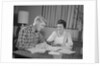 Couple man woman at table working on household accounts bills by Anonymous