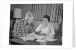 Couple man woman at table working on household accounts bills by Anonymous