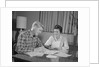 Couple man woman at table working on household accounts bills by Anonymous