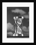 Hourglass against background of clouds by Anonymous