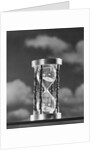 Hourglass against background of clouds by Anonymous
