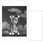 Hourglass against background of clouds by Anonymous