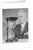 Elderly man soft focus behind hourglass by Anonymous