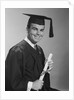 Smiling man holding diploma wearing graduation robes by Anonymous