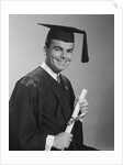 Smiling man holding diploma wearing graduation robes by Anonymous