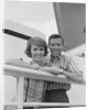 Portrait smiling couple standing by shipboard rail by Anonymous