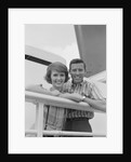 Portrait smiling couple standing by shipboard rail by Anonymous