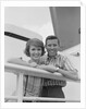 Portrait smiling couple standing by shipboard rail by Anonymous