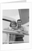 Portrait smiling couple standing by shipboard rail by Anonymous