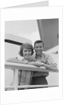 Portrait smiling couple standing by shipboard rail by Anonymous