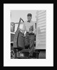 Delivery man stepping out of truck holding clipboard by Anonymous