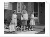 Mother and two daughters carrying shopping bags packages into house by Anonymous