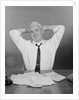 Smiling man working on family budget papers at desk by Anonymous