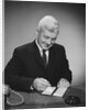 Man writing check from checkbook by Anonymous