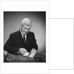 Man writing check from checkbook by Anonymous